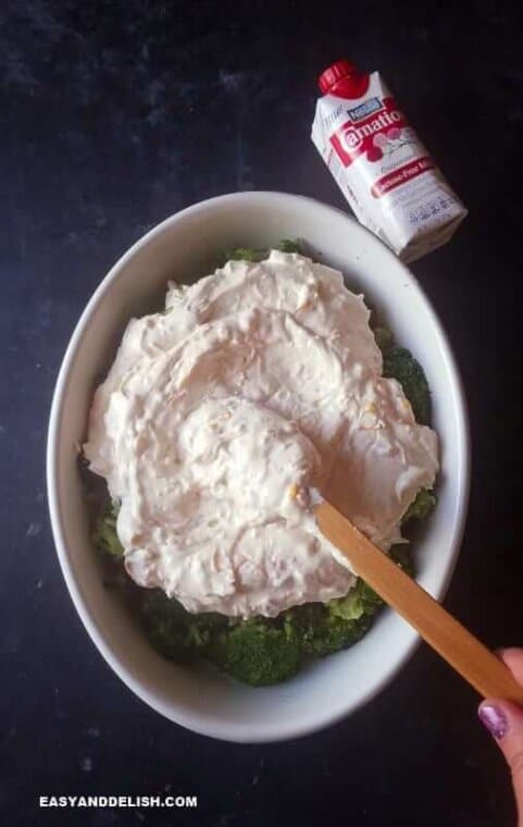 spreading cheese mixture over broccoli 