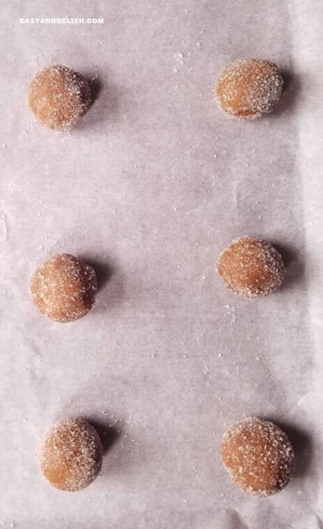 ginger spice cookies rolled into balls onto a baking sheet before baking