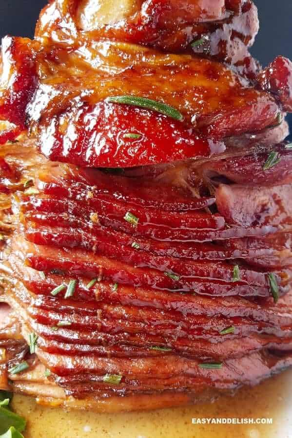 whole honey glazed ham facing sode down in a platter