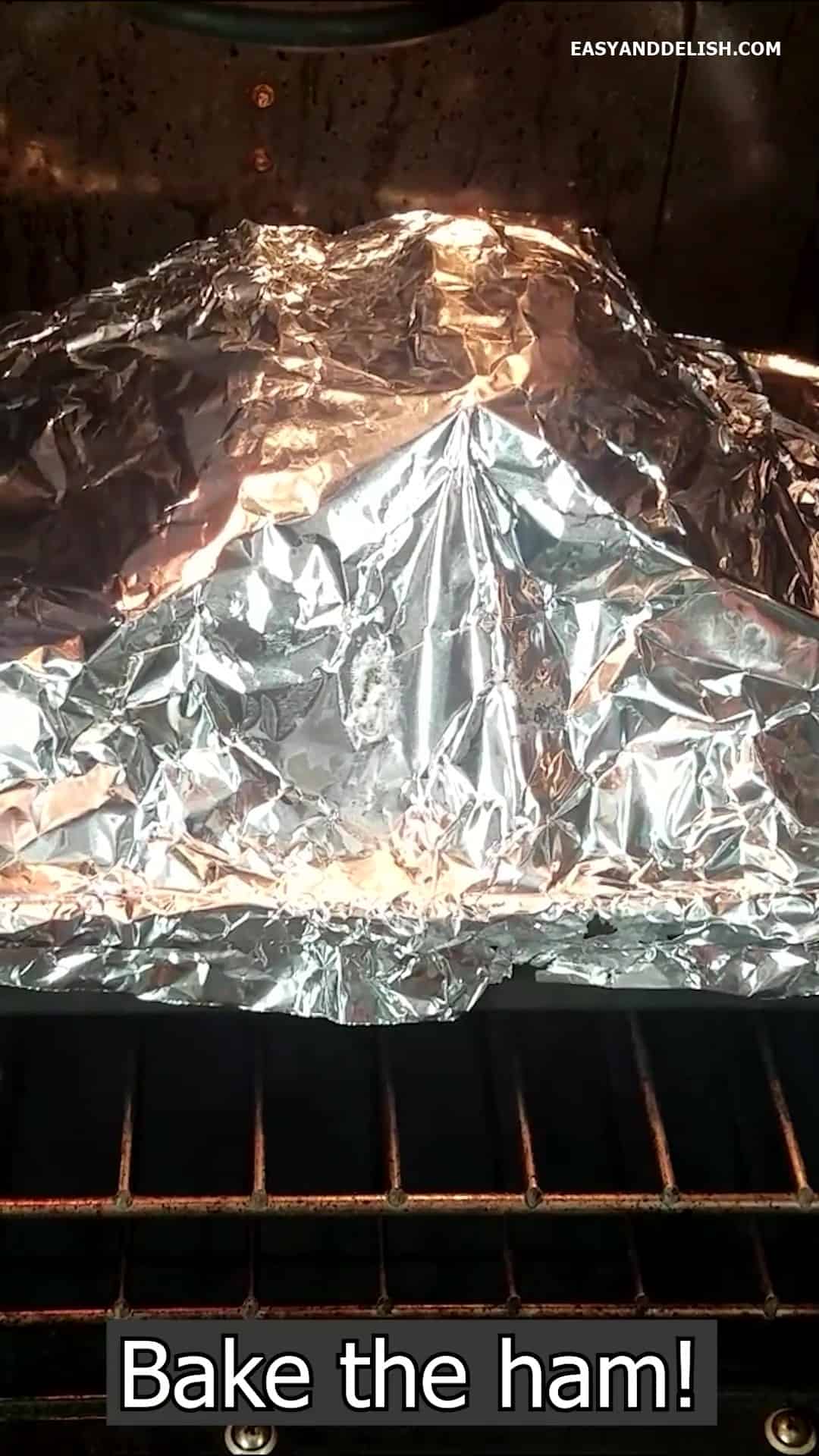 Meat tented with foil in the oven.