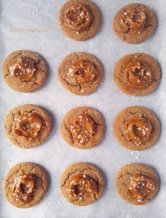several salted dulce de leche cinnamon cookies on a lined baking sheet 