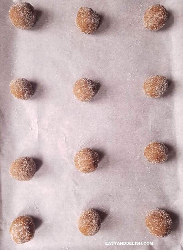 Salted Dulce de Leche Cinnamon Cookies Recipe that is gluten-free and full of warm spices that will comfort your soul. The best molasses cookies ever! #molasses #dulcedeleche #cookies #cinnamon #easyrecipe #christmas #holidays Dough rolled into balls on abaking sheet.