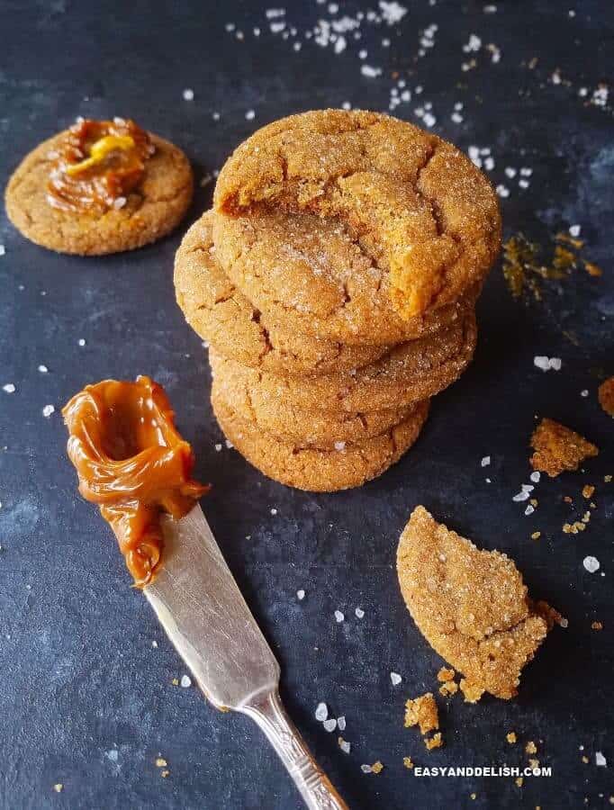 Salted Dulce de Leche Cinnamon Cookies Recipe that is gluten-free and full of warm spices that will comfort your soul. The best molasses cookies ever! #molasses #dulcedeleche #cookies #cinnamon #easyrecipe #christmas #holidays Soft and chewy molasses cookies piled up.