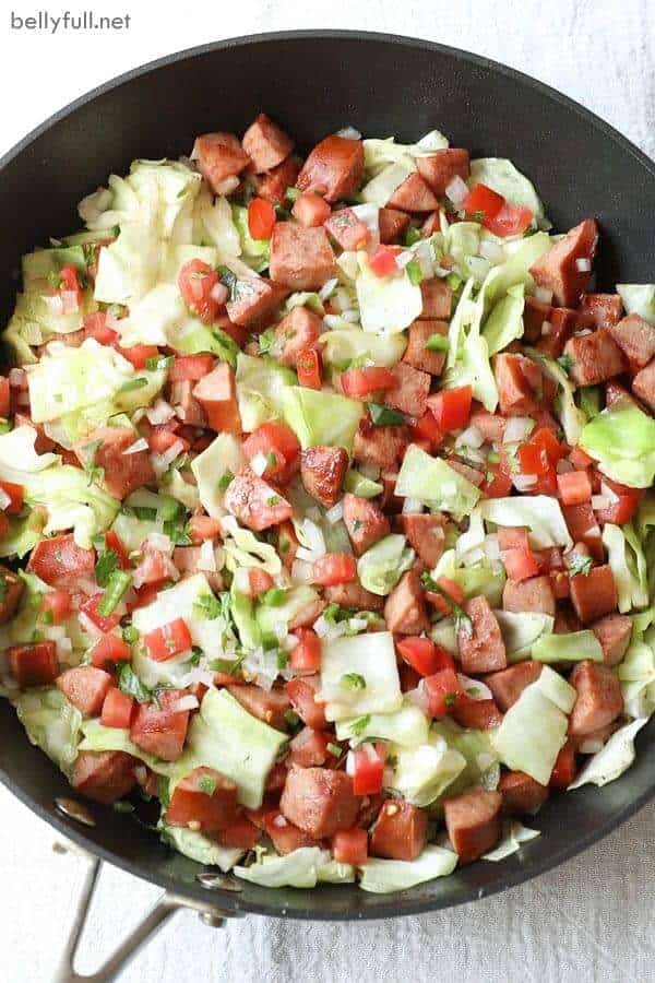 chopped sausage and cabbage in a skillet