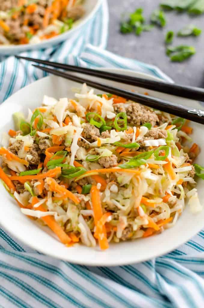 a bowl of egg roll desconstructed with chopsticks on the side