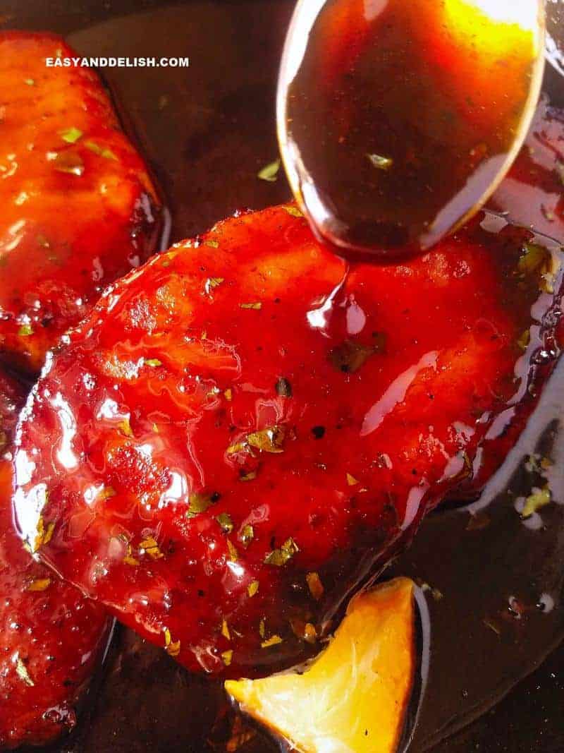 A close up of steak with pouring sauce