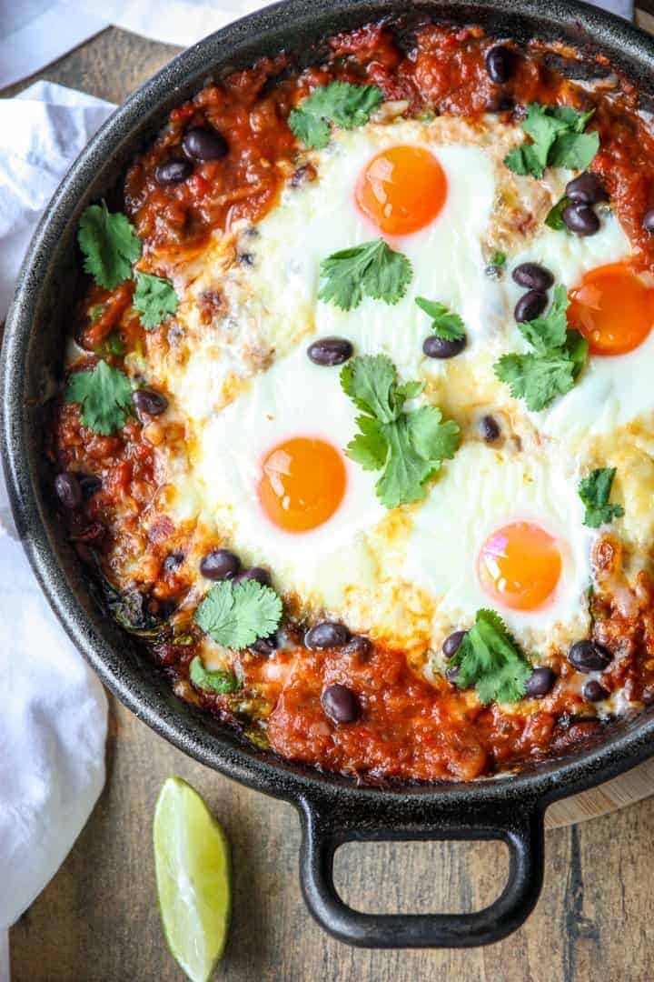 baked huevos rancheros ina skillet with a wedge of liem on the side as one of easy one pot meals