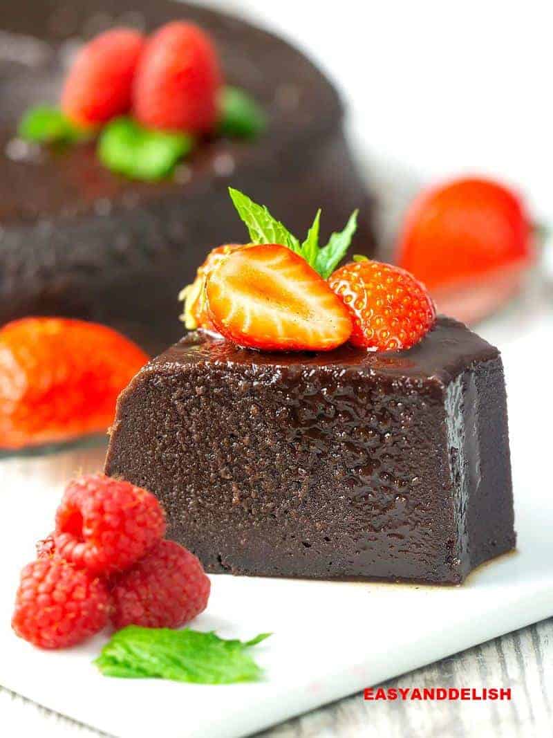 a slice of Brazilian chocolate bread pudding topped with berries.