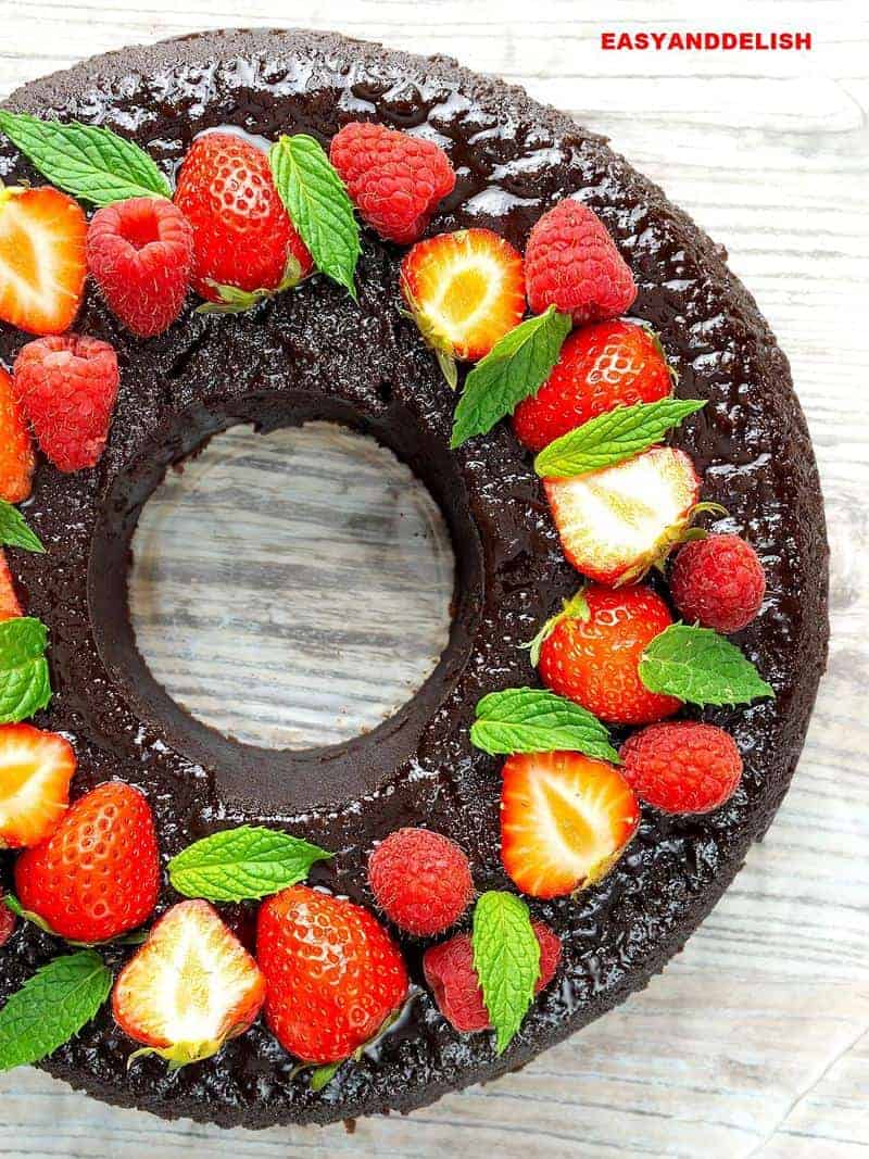 pudim de chocolate inteiro com frutas vermelhas no topo