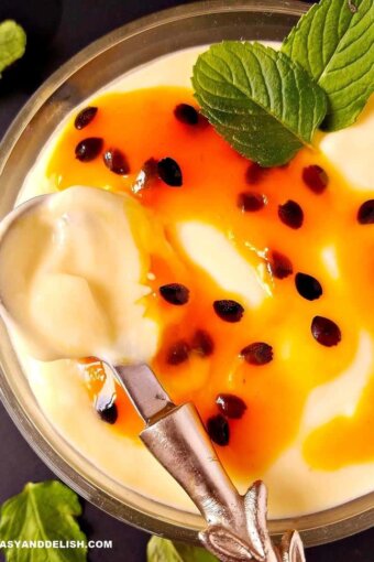 close up of passion fruit mousse with coulis being spooned