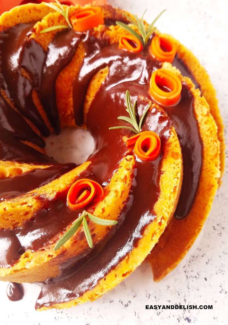 Close up of half of a decorated Brazilian carrot cake with chocolate sauce.