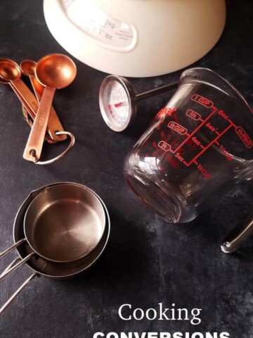 several cooking conversions tools such as scale, measurement cups and spoons, thermometer, etc