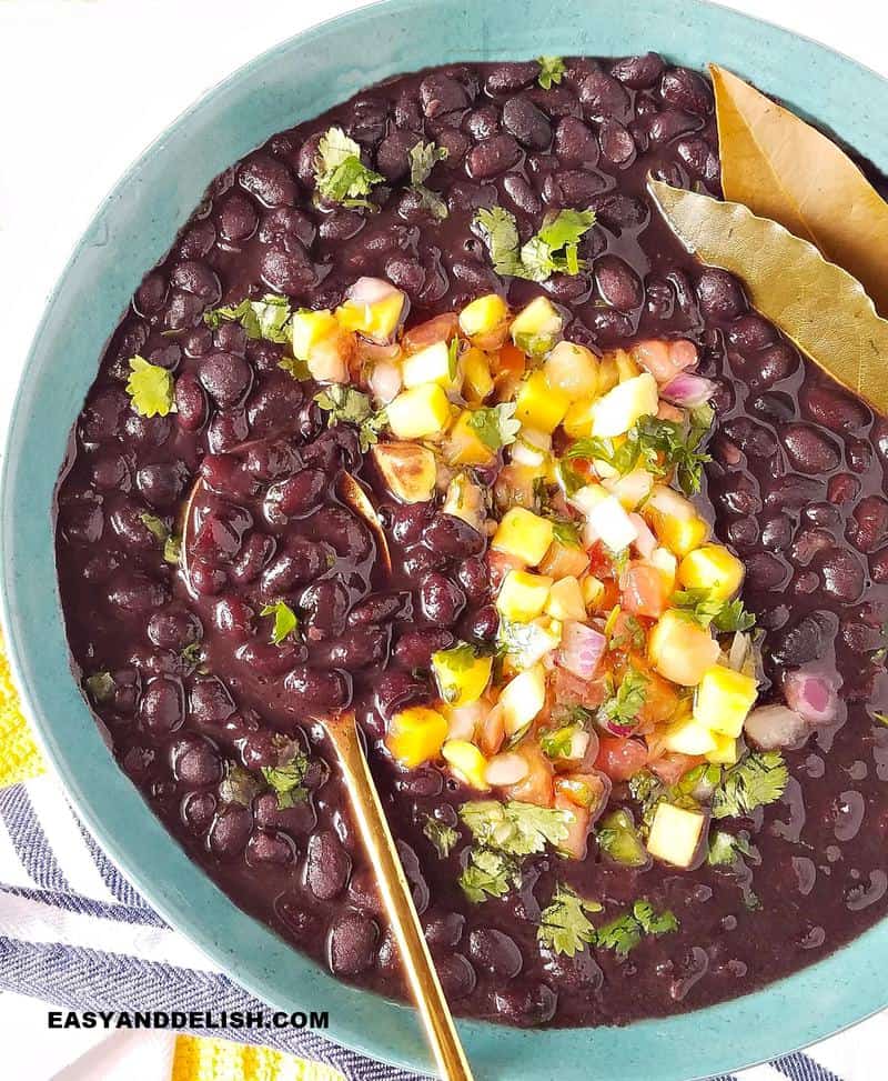 legumes in a bowl with bay leaves and pico de gallo