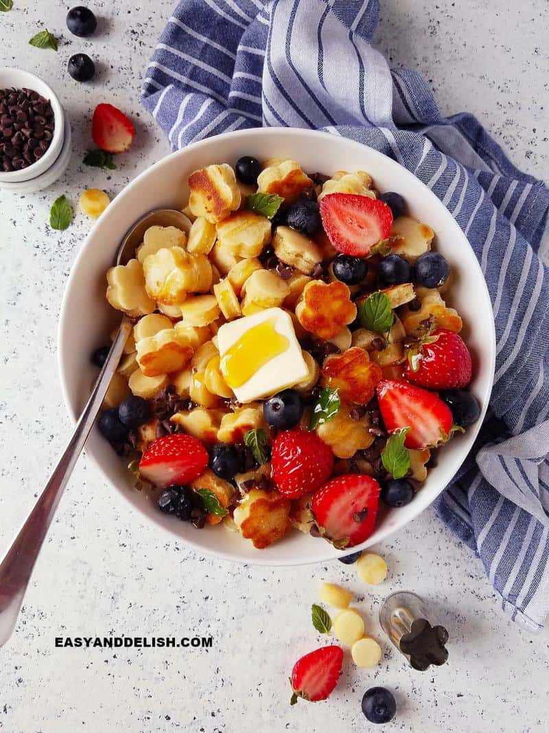 breakfast over the table with a bowl of food and toppings