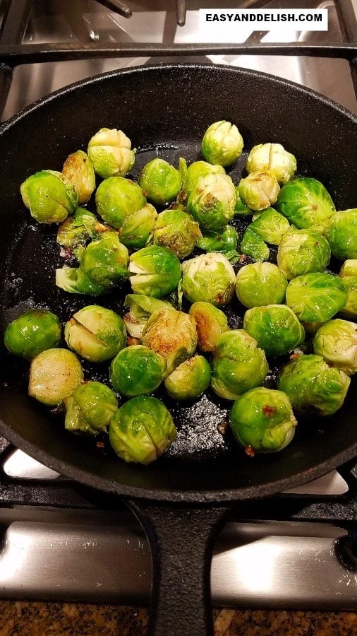 vegetables being sauteed in a skillet