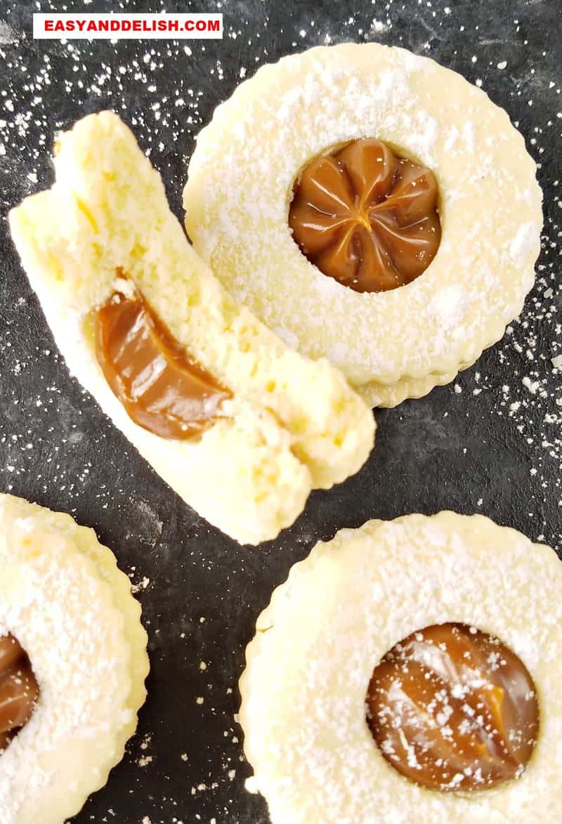 cornstarch alfajores, some whole and one partially eaten