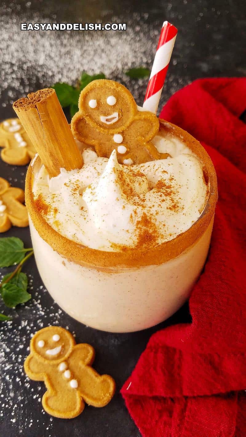 close up of a holiday drink in a glass wwith gingerbread man cookies