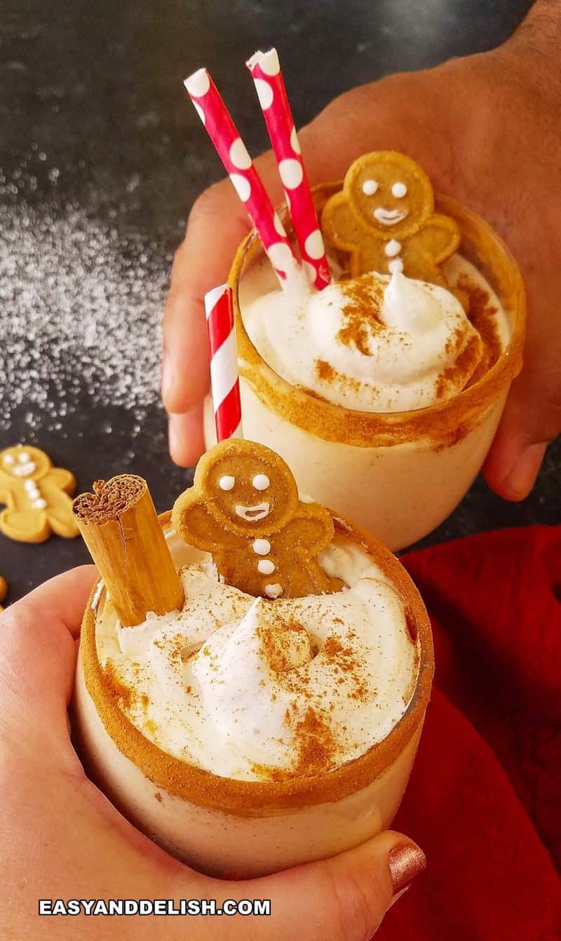 2 hands toasting with glasses of eggnog
