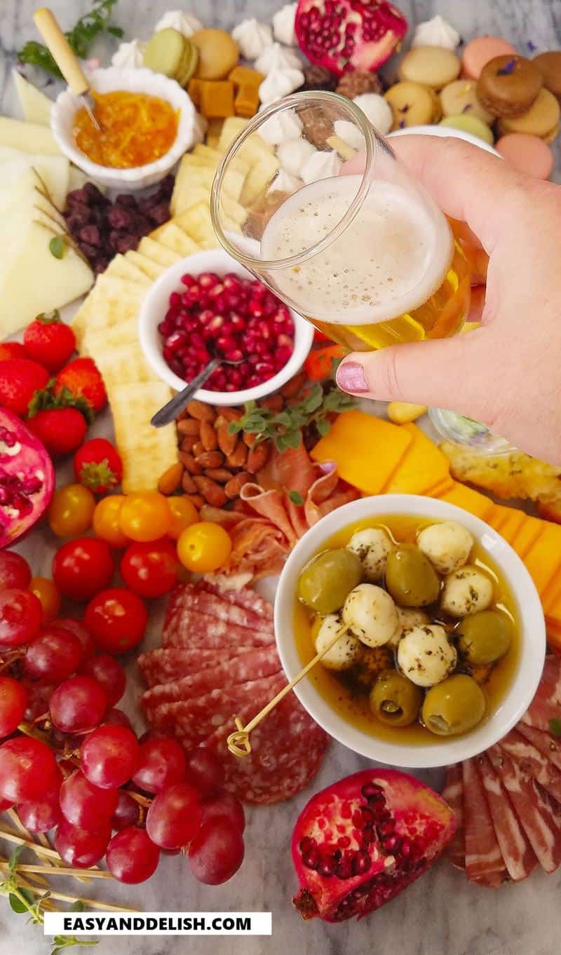 A glass of champagne over a appetizer platter. 