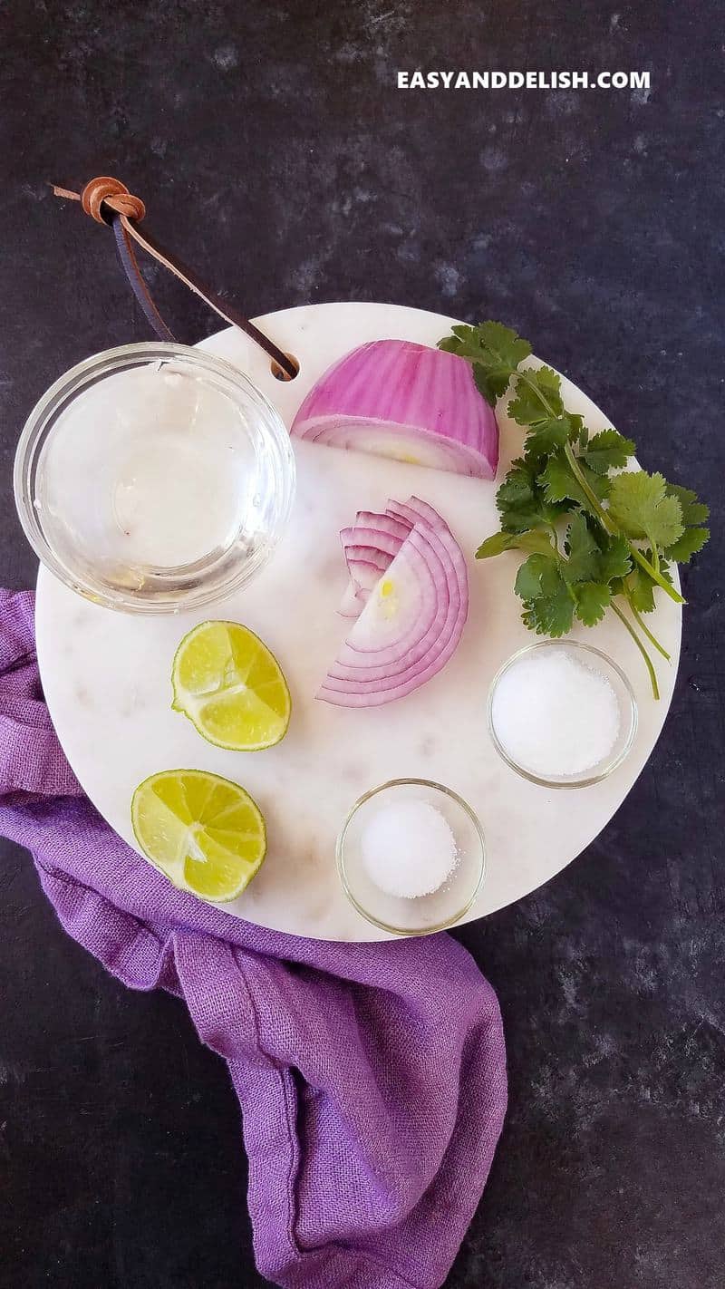 ingredientes for pickled onions on a marble baord