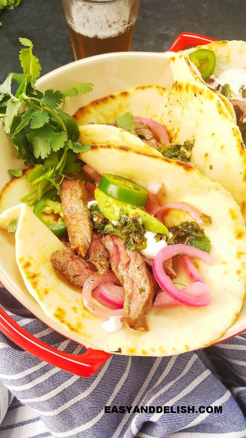 several marinated skirt steak tacos in a bowl