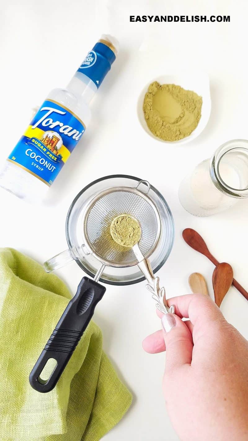 matcha tea powder in a spoon to be passed through a sieve