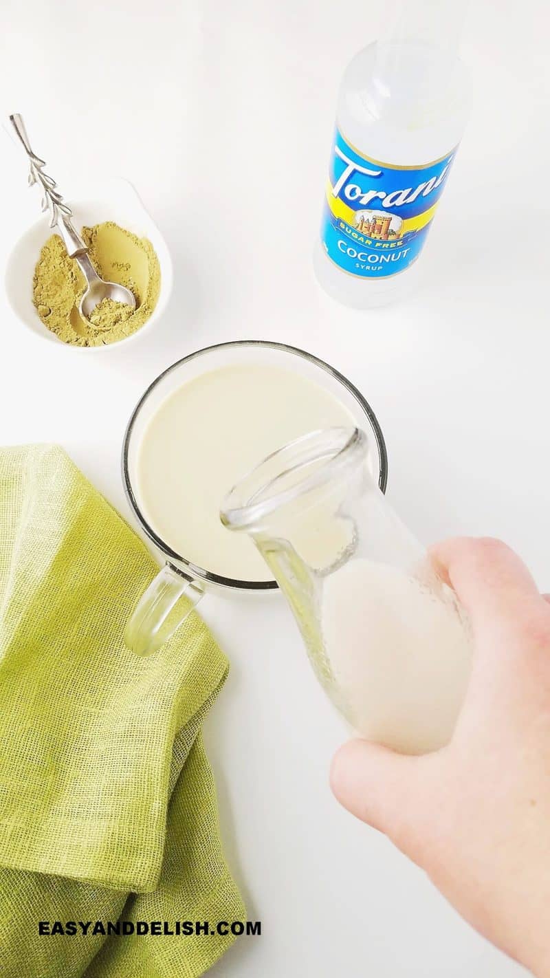 frothed milk being poured in a teacup to make matcha latte recipe