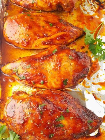 several chicken breasts baked in a baking sheet