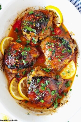 close up of baked chicken thighs in a baking dish