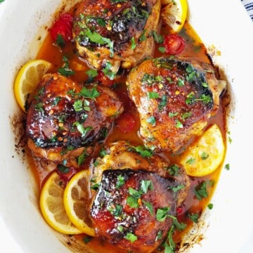 close up of baked chicken thighs in a baking dish