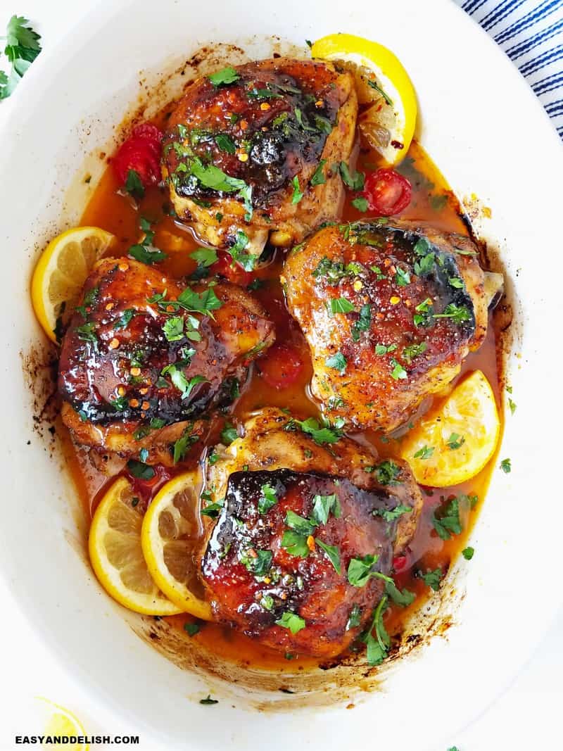 close up of baked chicken thighs in a baking dish