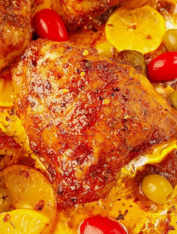 close up of baked bone in chicken thighs in a sheet pan