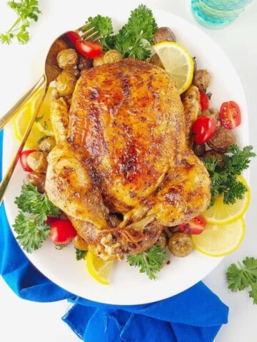 instant pot whole chicken in a platter with veggies