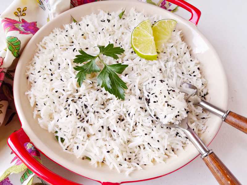 a bowl of basmati rice with garnishing on top