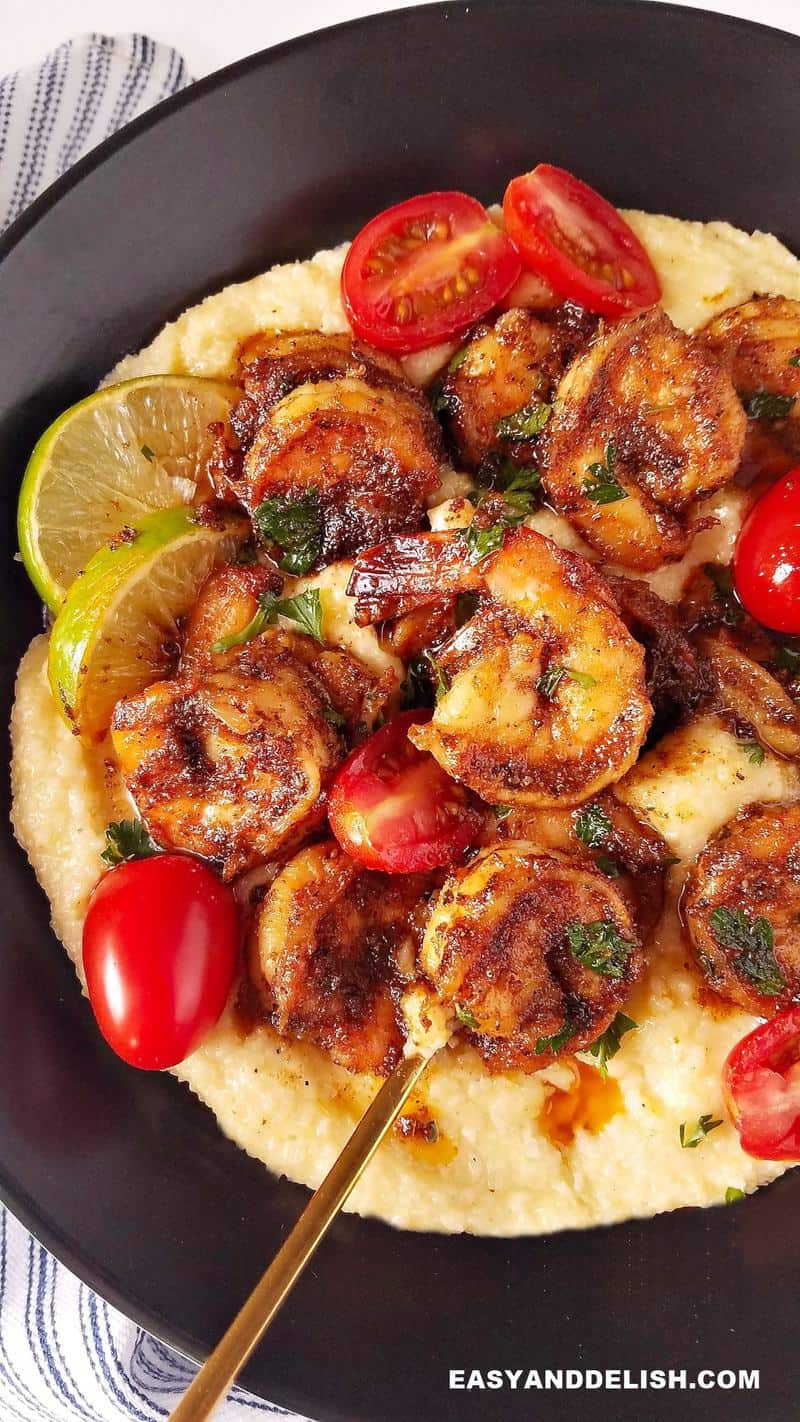 close up of a bowl with blackenened shrimp and grits