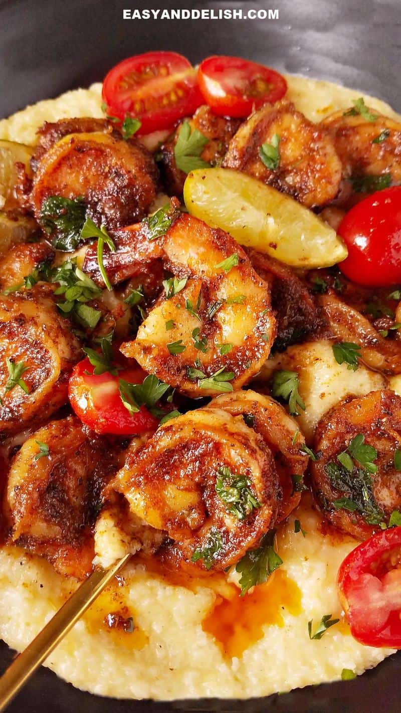 close up image with Cajun Blackened shrimp, grits and veggies