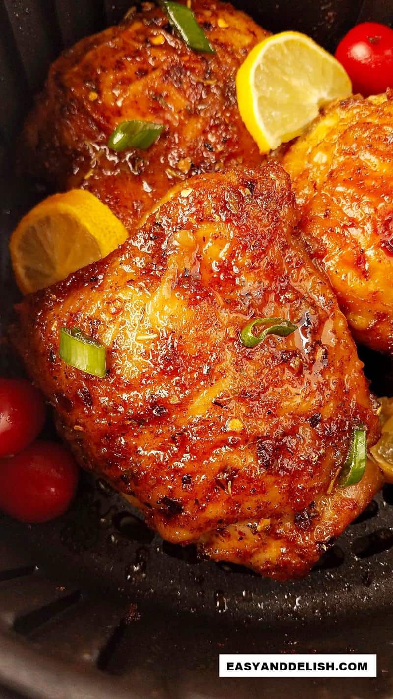 close up of fried bird with lemon and veggies 