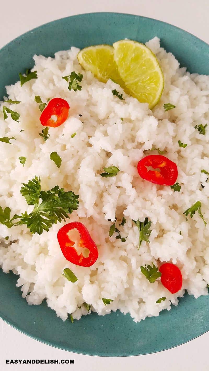 Close up of Instant Pot Jasmine Rice in a bowl topped with sliced chillies and limes