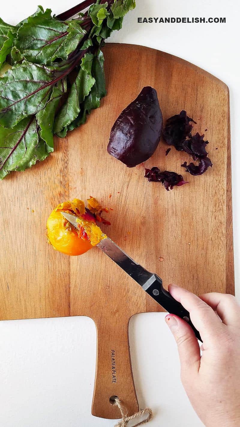 a knife peeling beets over a cutting board