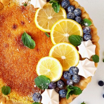 lemon ches spie topped with berries and meringues