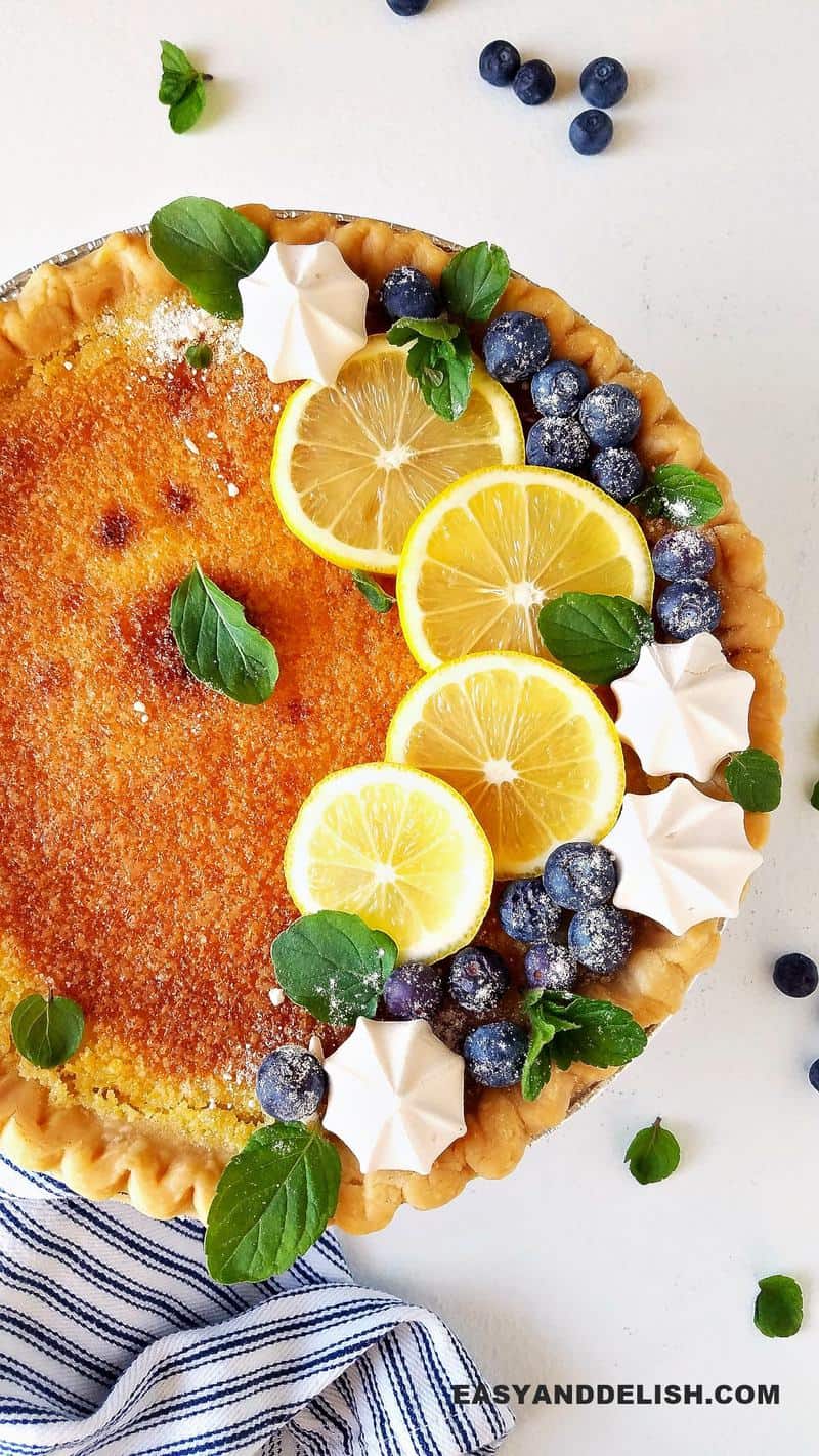 lemon chess pie topped with berries and meringues