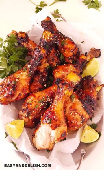 air fryer chicken legs in a tray with garnishes