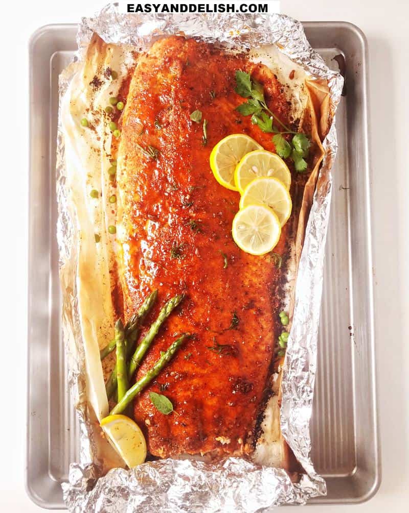 baked salmon whole with garnishes on top