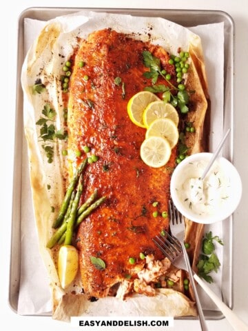 baked blackened salmon on a tray with garnishes