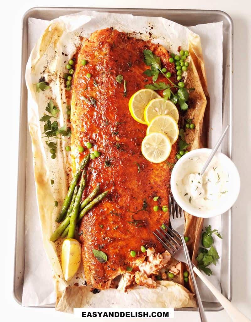 baked blackened salmon on a tray with garnishes