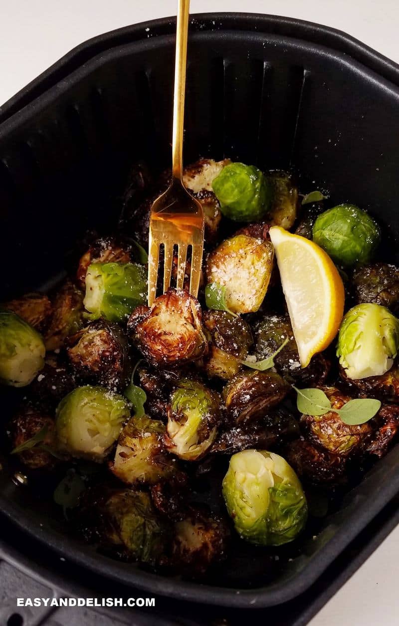 brussels sprouts in air fryer with a fork