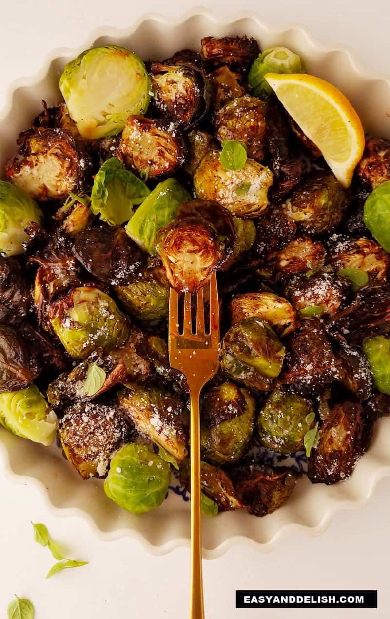 a bowl of air fryer brussels sprouts with a fork in the middle