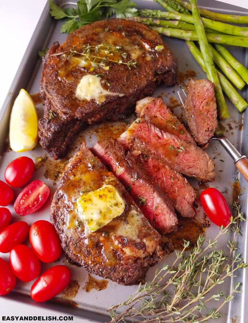 air fryer steak with veggies in a baking sheet