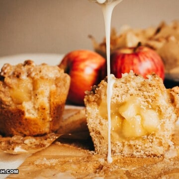 whole and cut in half drizzled apple crumble muffins