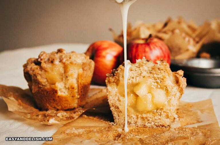 whole and cut in half drizzled apple crumble muffins